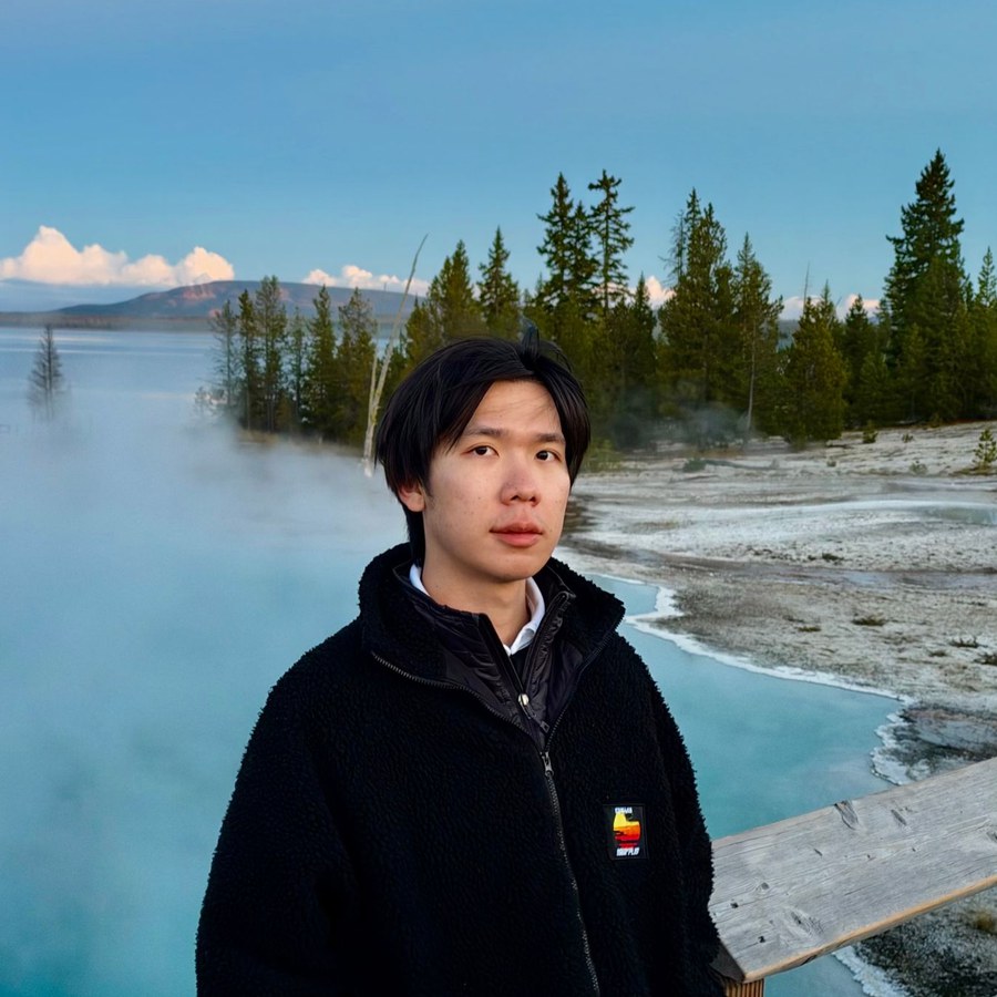 Yuwei Xiao at a hot spring in Yellowstone at dusk